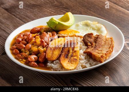 Bandeja paisa, typical dish at the Antioqueña region of Colombia. It consists of chicharrón (fried pork belly), black pudding, sausage, arepa, beans, Stock Photo