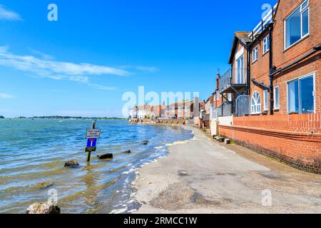 Rising tide flooding the seafront access road, Bosham, a south coast coastal village in Chichester Harbour, West Sussex, southern England, UK Stock Photo