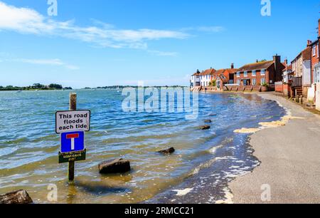 Rising tide flooding the seafront access road, Bosham, a south coast coastal village in Chichester Harbour, West Sussex, southern England, UK Stock Photo