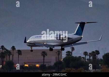 Palm Springs, California, USA. 13th July, 2022. A United Express regional passenger jet landing at the airport at dusk in Palm Springs California. (Credit Image: © Ian L. Sitren/ZUMA Press Wire) EDITORIAL USAGE ONLY! Not for Commercial USAGE! Stock Photo