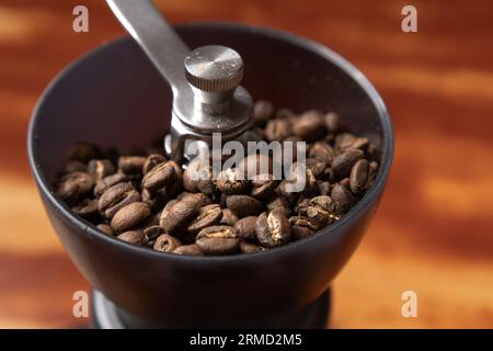 Roasted coffee beans in a coffee grinder Stock Photo