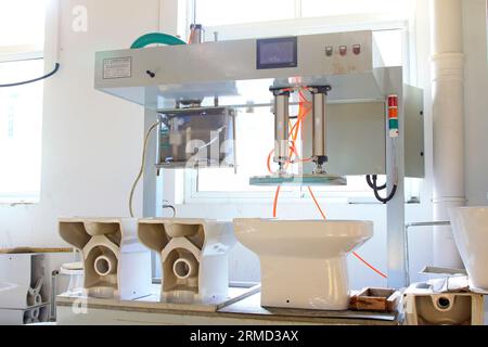 Ceramic toilet products in a workshop production line Stock Photo