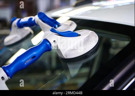 Suction pads for car windshield installing in workshop Stock Photo