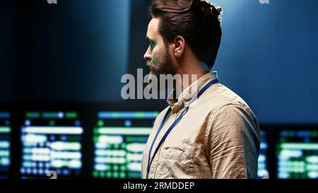 Close up of computer scientist monitoring server hub, optimizing it for data processing requirements of AI workloads. Supervisor overseeing neural network high tech facility used for machine learning Stock Photo