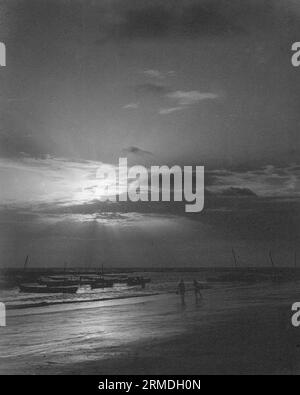 old vintage black and white early 1900s silver gelatin toned print Indian fishing boats beach India Stock Photo