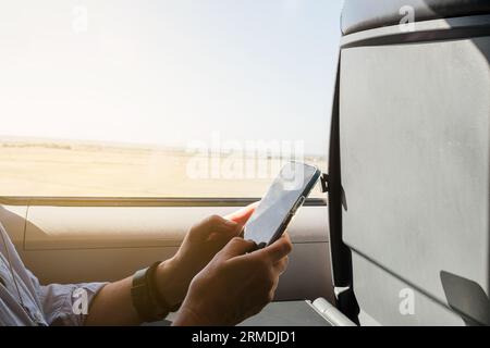 beautiful woman using smart phone while sitting on a train Stock Photo