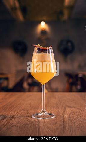 Elegant eggnog yellow passion fruit cocktail on bar table Stock Photo