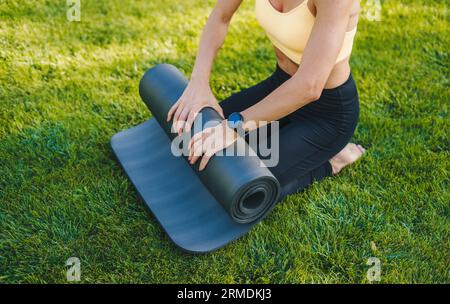 Crop woman doing yoga on green grass Stock Photo