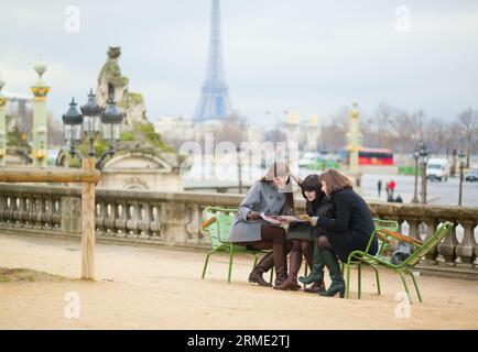 Tourists in Paris planning their trip using map Stock Photo