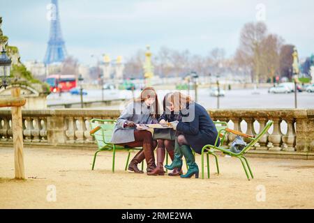 Tourists in Paris planning their trip using map Stock Photo