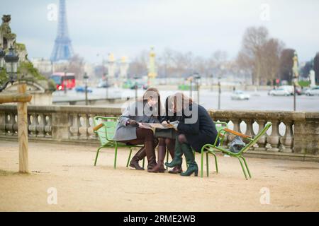 Tourists in Paris planning their trip using map Stock Photo