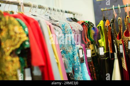 Evening dresses hang on a shelf in a store Stock Photo