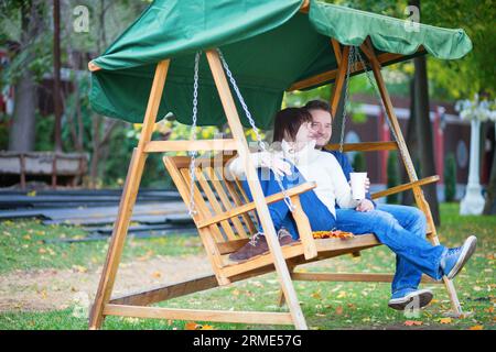 Romantic couple swing in the autumn park Stock Photo - Alamy