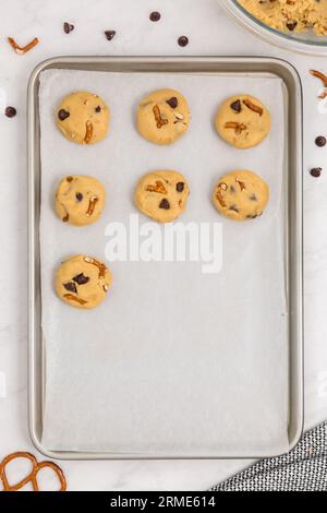 Raw Chocolate Chip Pretzel Cookies on baking tray with parchment paper Stock Photo