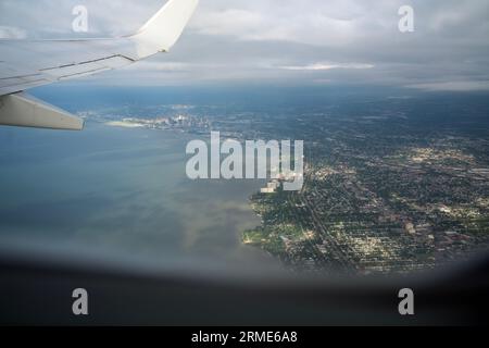 View from inside airplane flying over Cleveland Stock Photo