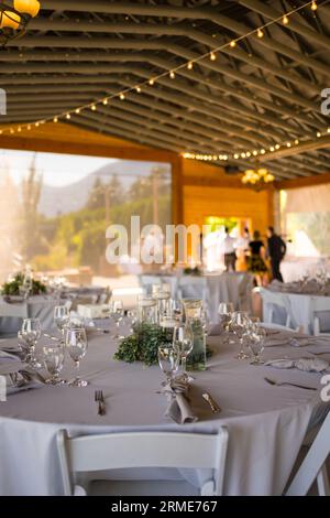 Charming table set up awaits guests at rustic barn wedding Stock Photo