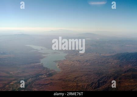 Large body of water in a rocky landscape viewed from high altitude Stock Photo