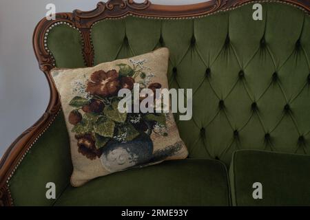Green sofa with stiched pillows in green color, close-up. Stock Photo