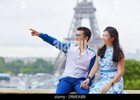 Young romantic Asian couple on Trocadero view point near the Eiffel tower in Paris, France Stock Photo