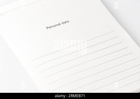 Opened notebook on personal data page. Customer filling form. Close up. Selective focus Stock Photo