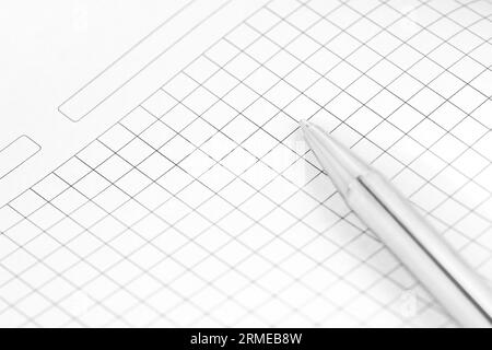 Close-up of silver pen laying on paper. Empty white sheet on working table. Office stationery concept Stock Photo