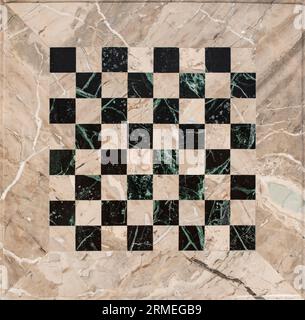 Beige and black marble mosaic chess board, empty textured backdrop, close up Stock Photo