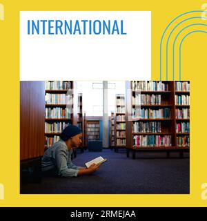 Composite of international school library month text and biracial woman lying and reading book Stock Photo