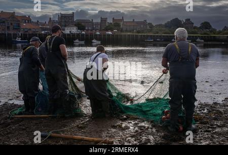 Traditional salmon fishermen fishing at the mouth of the River Tweed, Berwick upon Tweed, Northumberland, England, UK Stock Photo