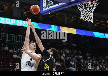 Finn Delany of the New Zealand basketball team and Ahmad Hamarsheh of the Jordan basketball team