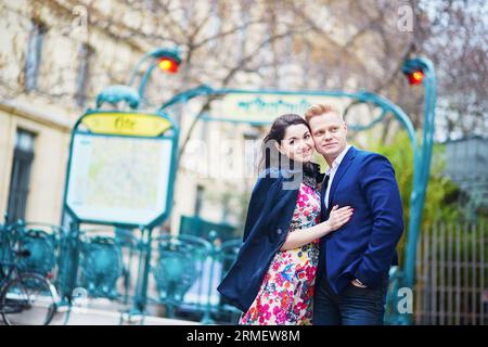 Romantic couple hugging tenderly near the entrance in Parisian underground Stock Photo