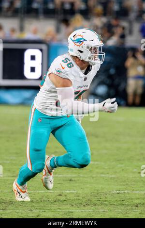 Atlanta Falcons quarterback Logan Woodside (11) is hit by Miami Dolphins  linebacker Garrett Nelson (56) in the first half of a preseason NFL  football game, Friday, Aug. 11, 2023, in Miami Gardens