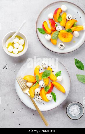 Grilled Peach Salad with Mozzarella Pearls on Bright Background Stock Photo