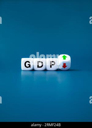 GDP business concept. Word "GDP" Gross domestic product on white cube block near up and down arrows on flipping block. Business growth and measure for Stock Photo