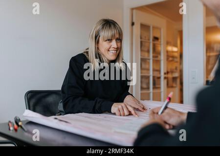 Smiling engineers working on plans Stock Photo