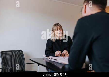 Smiling engineers working on plans Stock Photo
