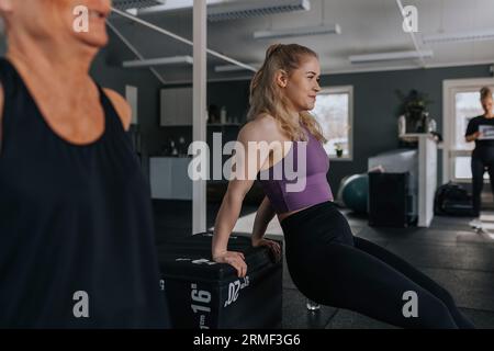 Smiling young woman training in gym Stock Photo