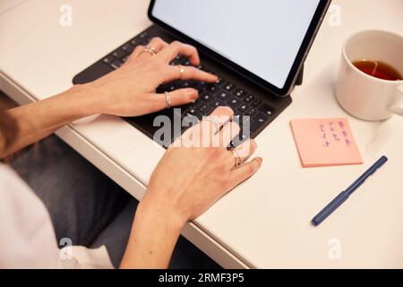 High angle view of woman's hands using laptop Stock Photo