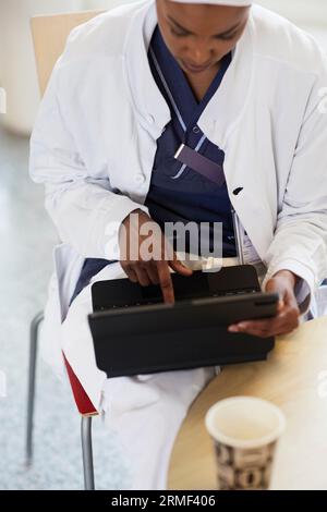 High angle view of female doctor using digital tablet Stock Photo