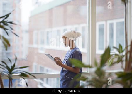 Female doctor standing and using digital tablet Stock Photo