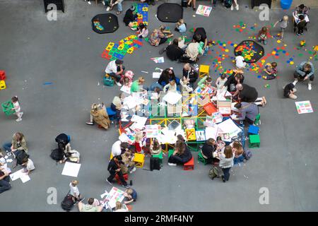 View from above looking down on families and children making art activities at the Tate Modern Art Gallery in London England UK 2023 KATHY DEWITT Stock Photo