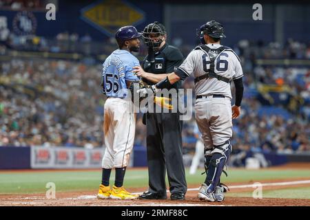 St. Petersburg, United States. 27th Aug, 2023. New York Yankees catcher Kyle  Higashioka (L) listens as home plate umpire Adam Beck (R) restrains Tampa  Bay Rays' Randy Arozarena after he was hit