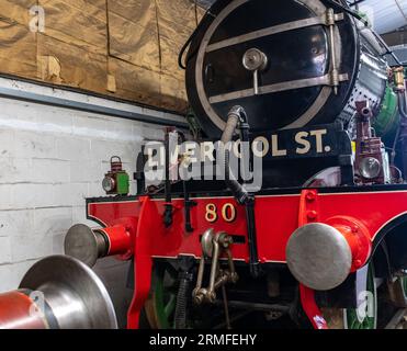 Bressingham, Norfolk, UK – August 21 2023. The front end of an old steam locomotive in a shed undergoing restoration Stock Photo