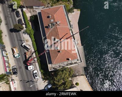 window installation company installs windows using a crane. captured by a drone Stock Photo