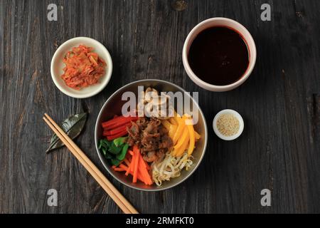 Top View Bibimbap Korean Mixed Rice. Rice Topped with Seasoned Vegetables, Meat, Mushroom, Add Spicy Chili Sauce Stock Photo