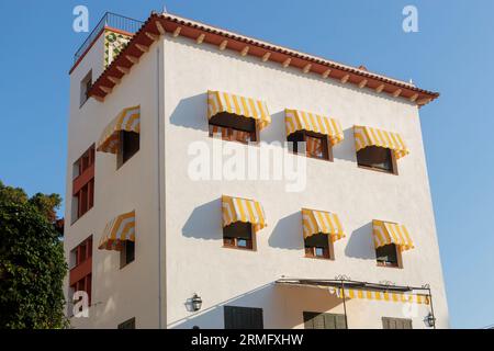 Tossa de Mar, Spain - 13 August 2023 Building with Elegant Yellow Awnings Stock Photo
