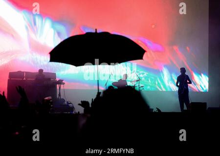 The Comet Is Coming play during a massive rainstorm on the Mountain Stage at Green Man Festival in Wales, UK, August 2023. Photo: Rob Watkins Stock Photo