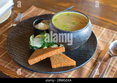 Traditional Russian fish soup (ukha) served in casserole Stock Photo