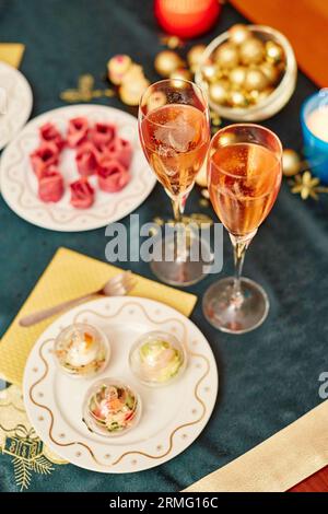 Decorated Christmas dining table with champagne and delicious snacks Stock Photo