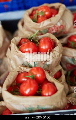 Large heap of fresh ripe organic tomatoes on farmer market in Paris, France Stock Photo