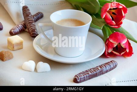 Morning coffee with cookies, heart-shaped pieces of sugar and flowers Stock Photo
